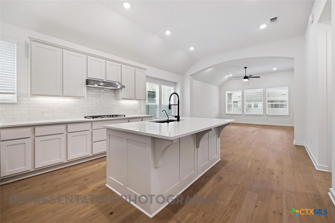 120 Fox Run Georgetown, TX 78628 - Photo 6 of 30 a kitchen with stainless steel appliances a sink stove and cabinets