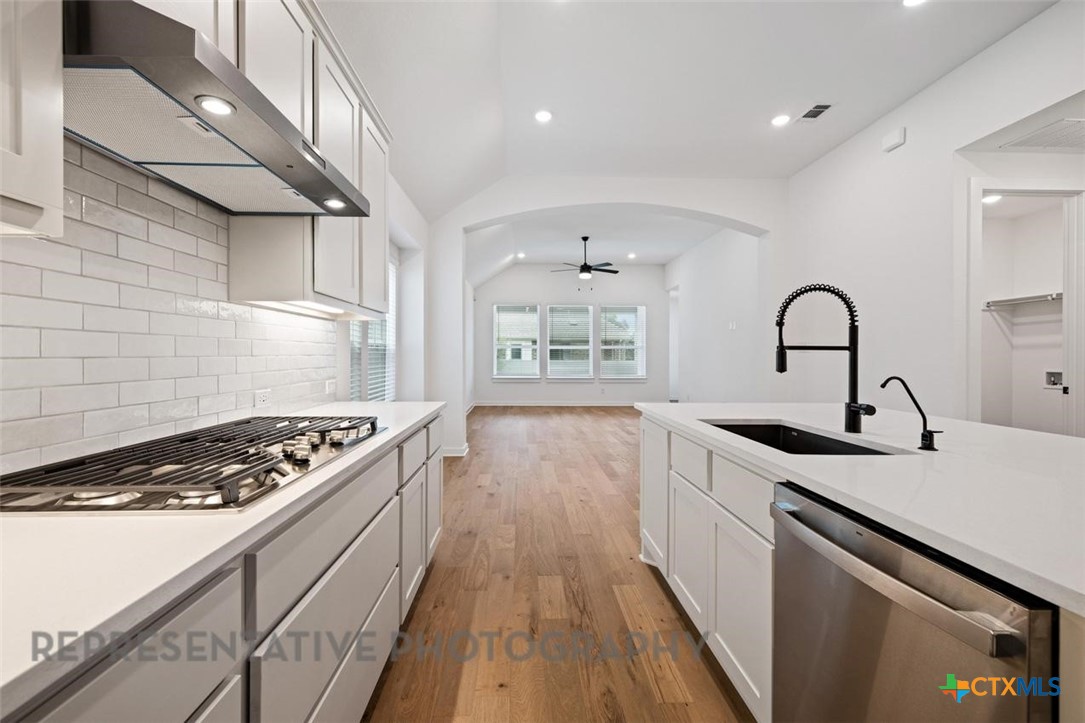 120 Fox Run Georgetown, TX 78628 - Photo 7 of 30 a kitchen with granite countertop a stove and a sink