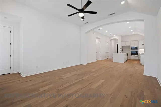 a view of a kitchen with a sink and a refrigerator