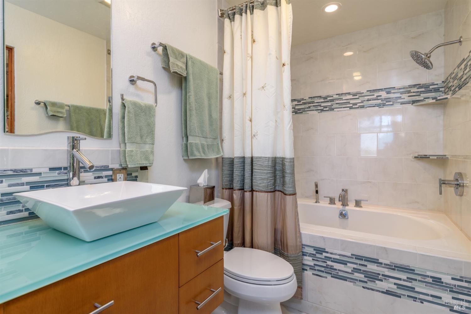 38120 Ocean Ridge Drive Gualala, CA 95445 - Photo 21 of 34 a bathroom with a sink a toilet a mirror and bathtub