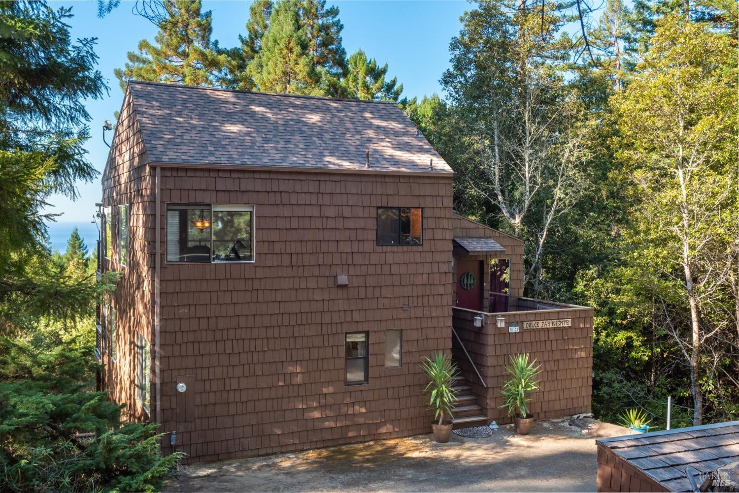 38120 Ocean Ridge Drive Gualala, CA 95445 - Photo 31 of 34 a front view of a house with a yard