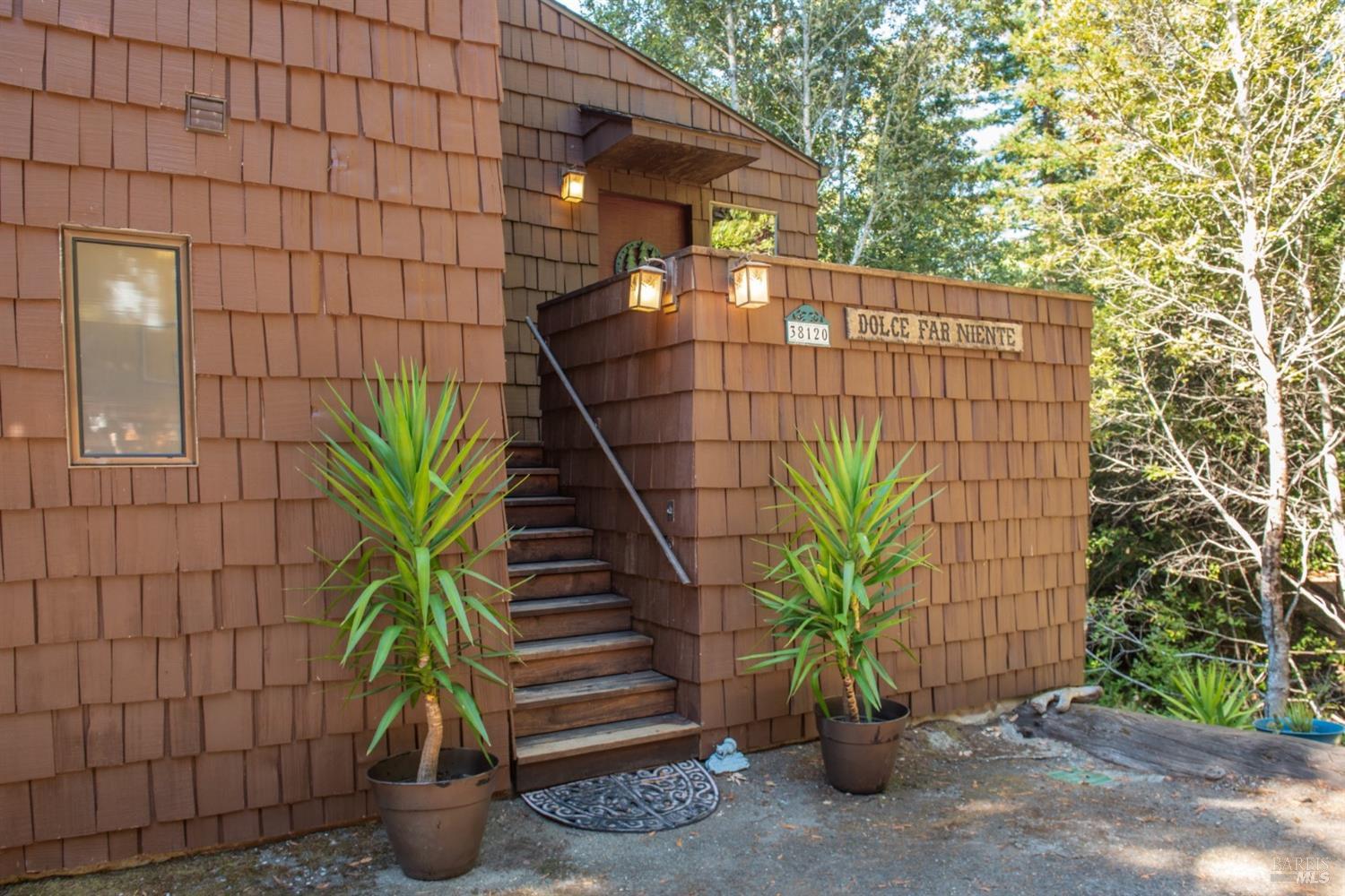 38120 Ocean Ridge Drive Gualala, CA 95445 - Photo 5 of 34 a potted plant sitting in front of a building