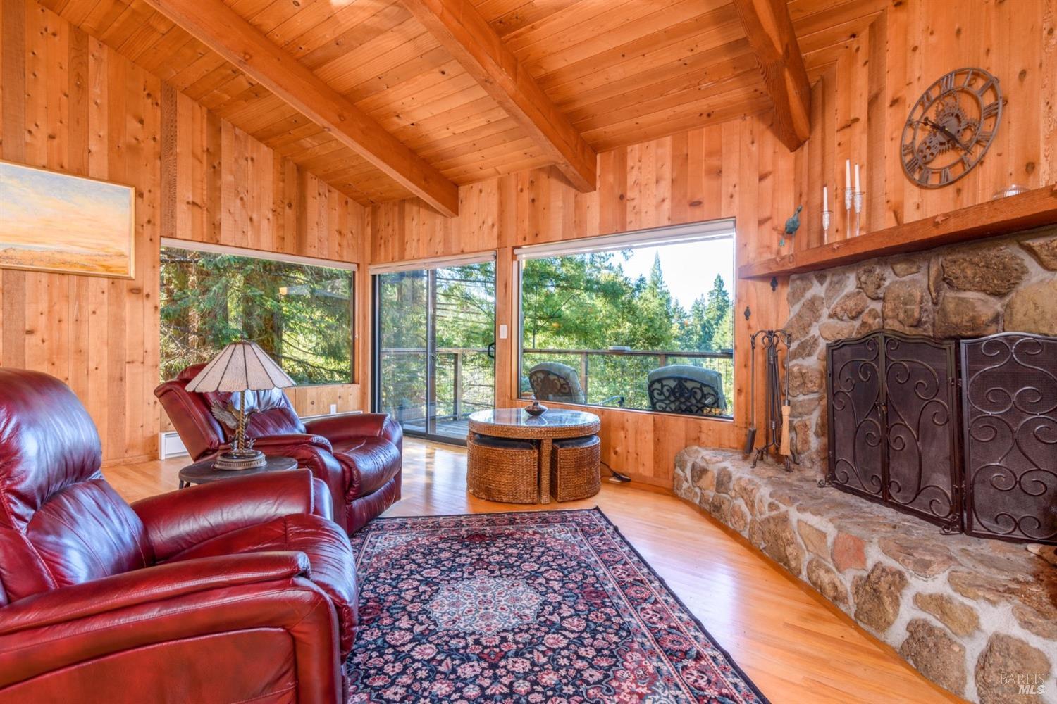 38120 Ocean Ridge Drive Gualala, CA 95445 - Photo 8 of 34 a living room with furniture a fireplace and large windows