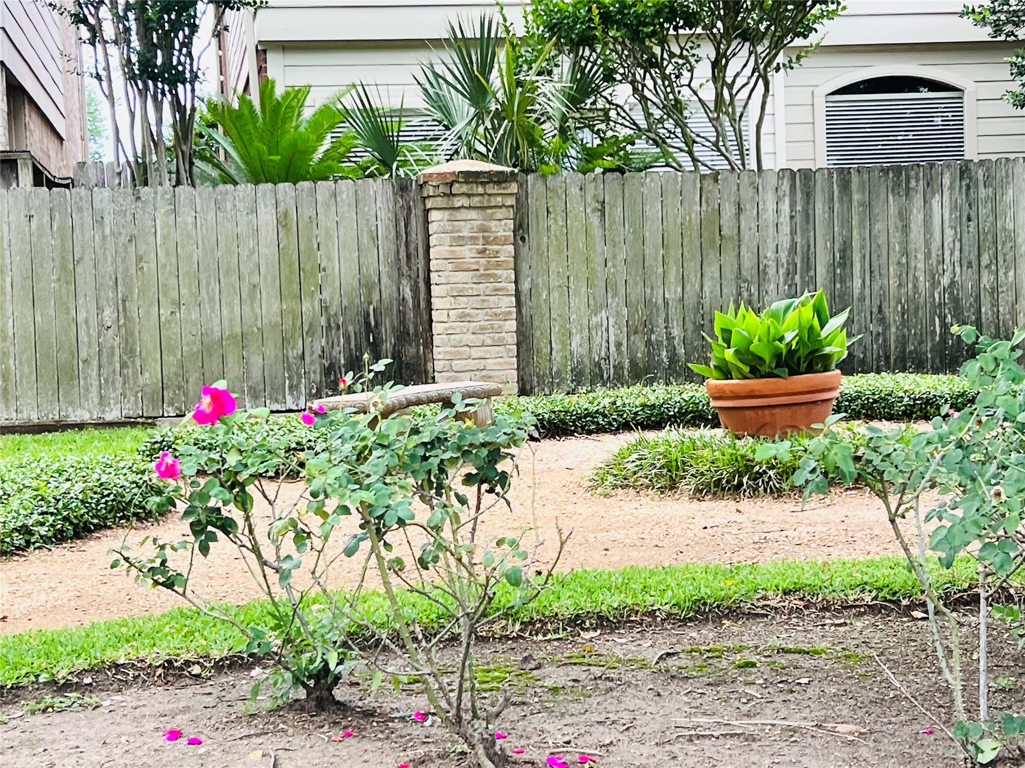 2800 Jeanetta Street, Unit 1702 Houston, TX 77063 - Photo 19 of 23 a front view of a house with a yard and a garden