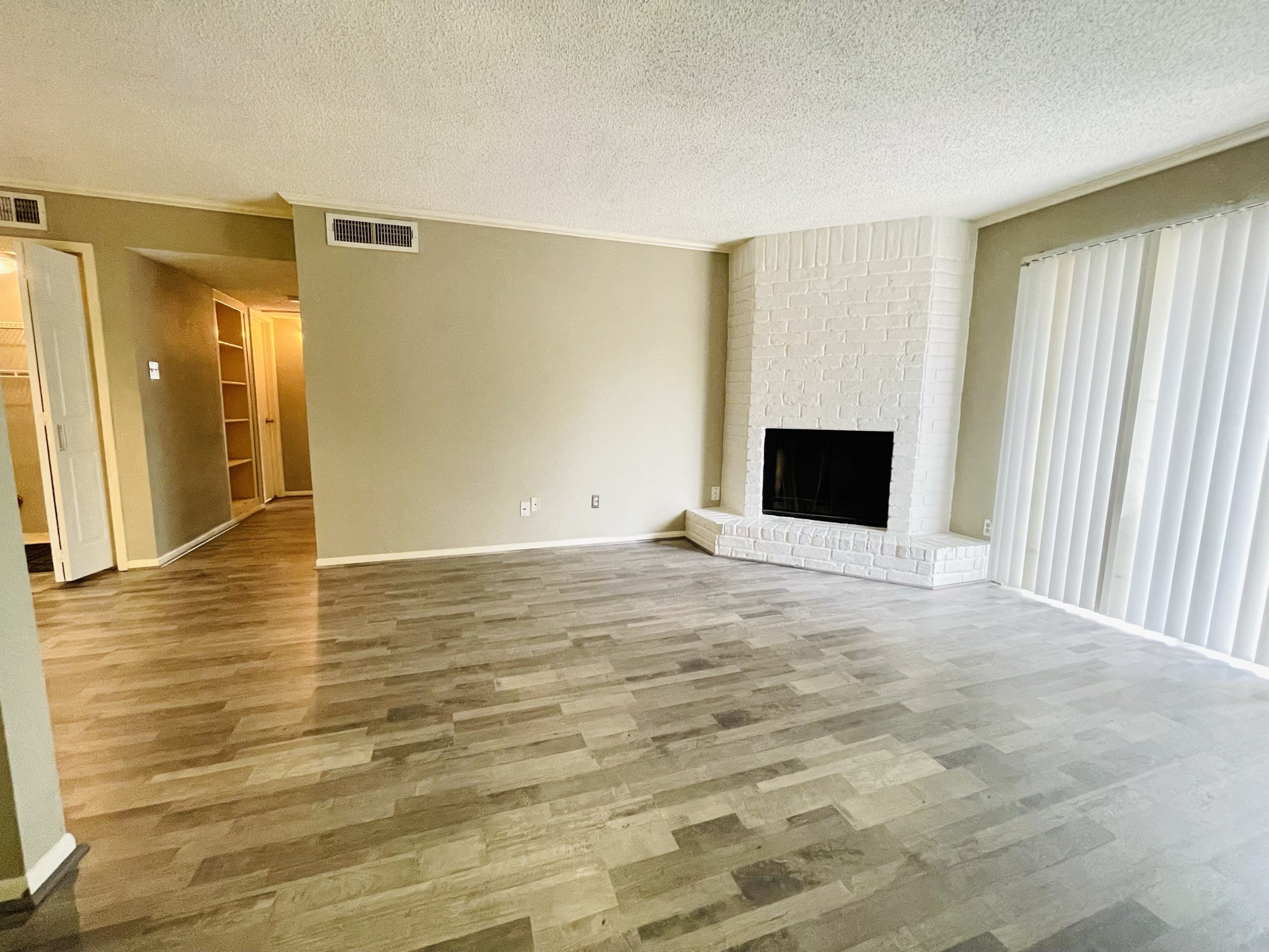 2800 Jeanetta Street, Unit 1702 Houston, TX 77063 - Photo 5 of 23 a view of an empty room with wooden floor and a window