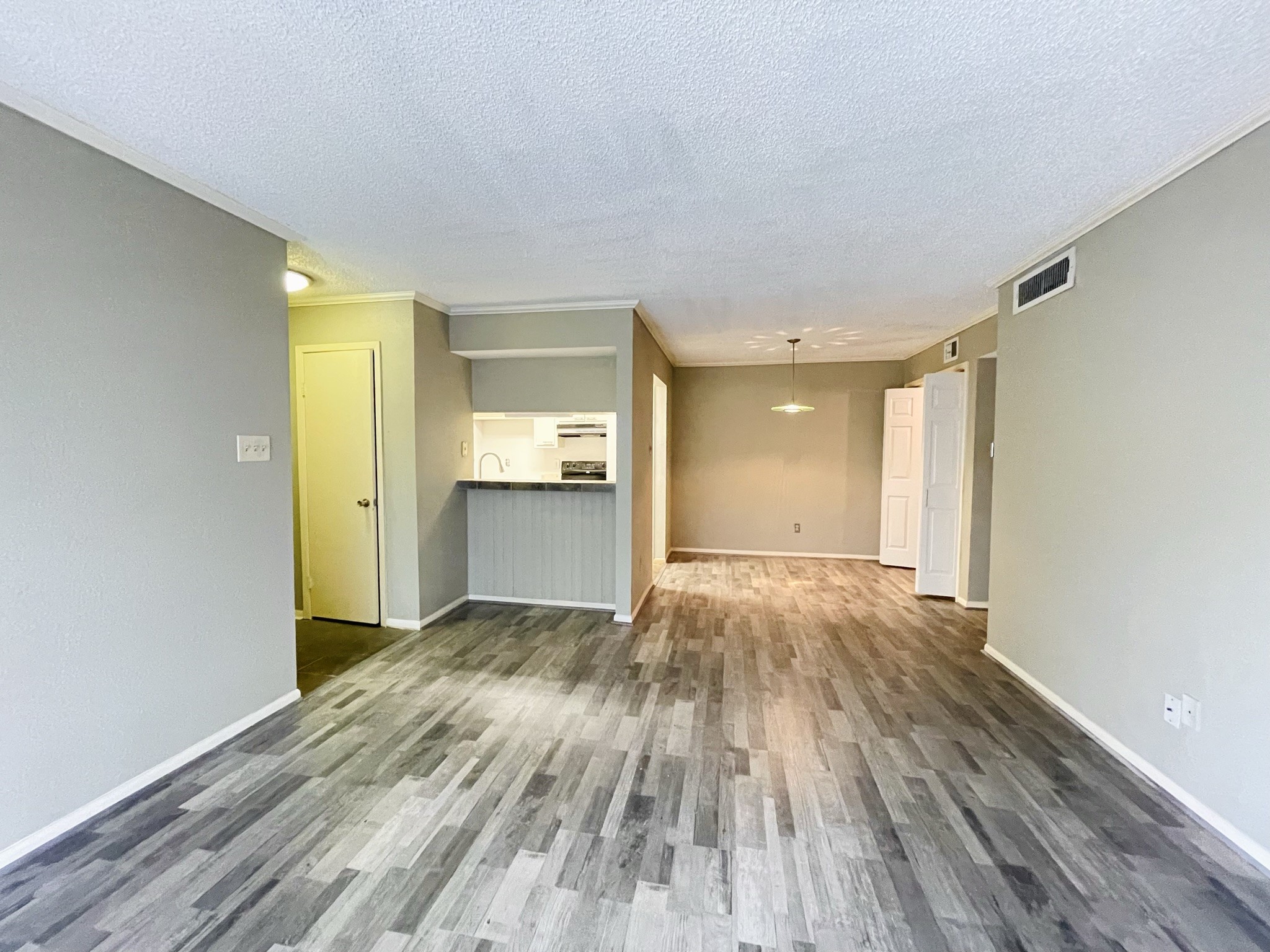 2800 Jeanetta Street, Unit 1702 Houston, TX 77063 - Photo 6 of 23 a view of an empty room and window and wooden floor