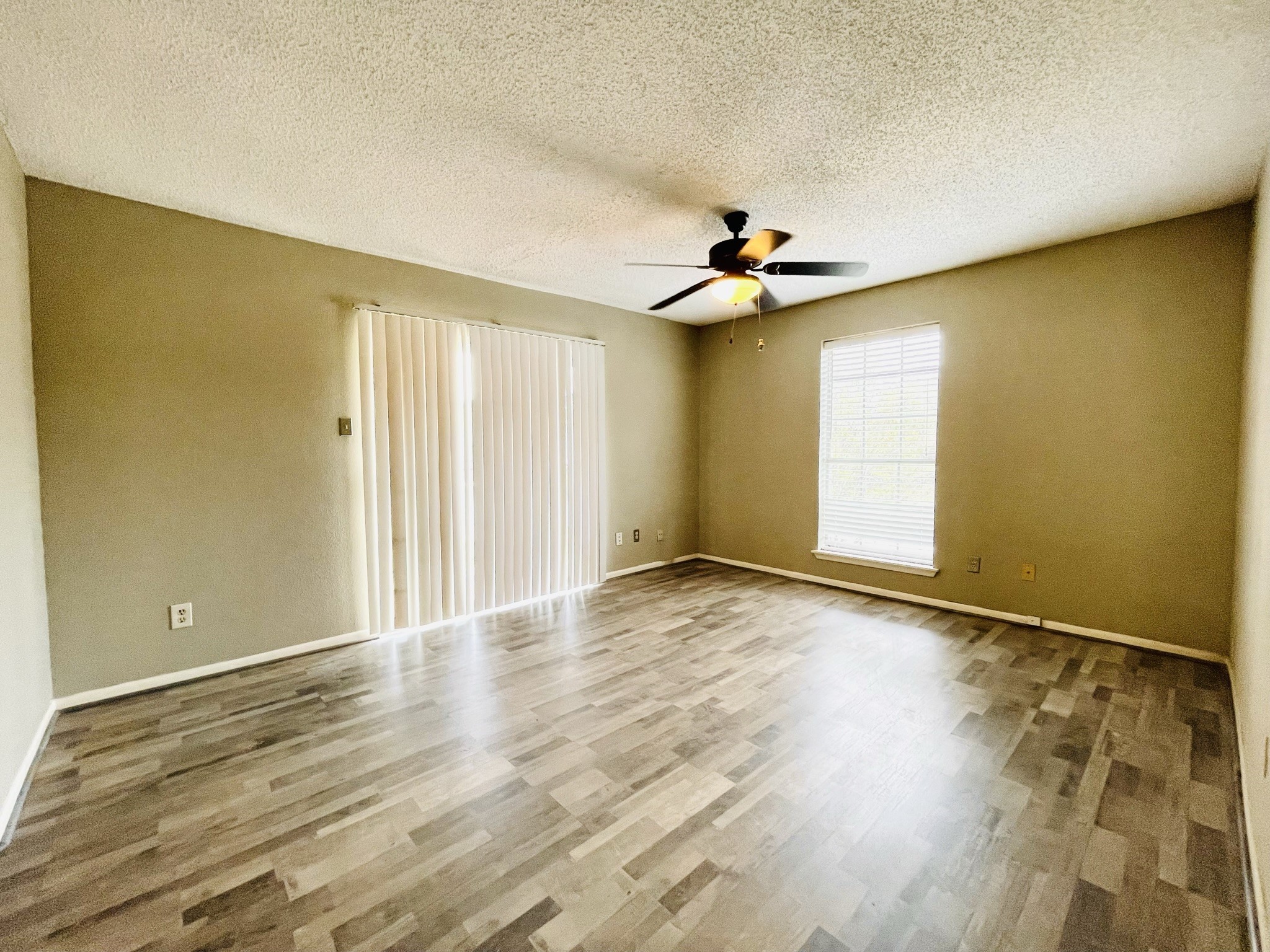 2800 Jeanetta Street, Unit 1702 Houston, TX 77063 - Photo 10 of 23 a view of an empty room with window and wooden floor