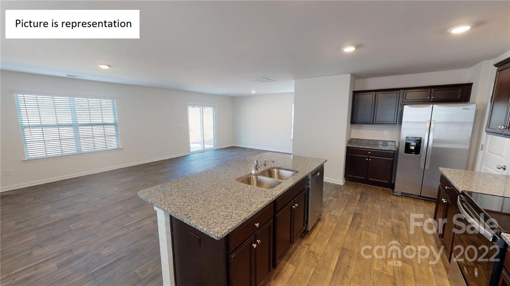 5026 Fandango Road York, SC 29745 - Photo 20 of 26 a kitchen with granite countertop a sink and a refrigerator