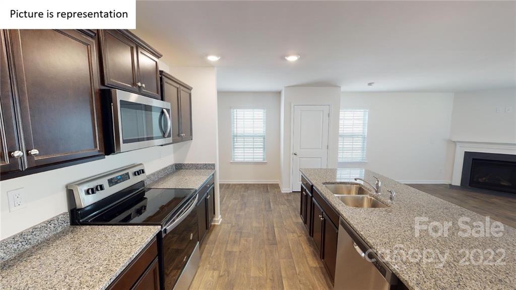 5026 Fandango Road York, SC 29745 - Photo 23 of 26 a kitchen with granite countertop a stove and a sink