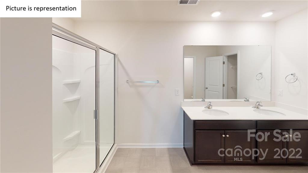 5026 Fandango Road York, SC 29745 - Photo 25 of 26 a bathroom with a sink a mirror and a shower