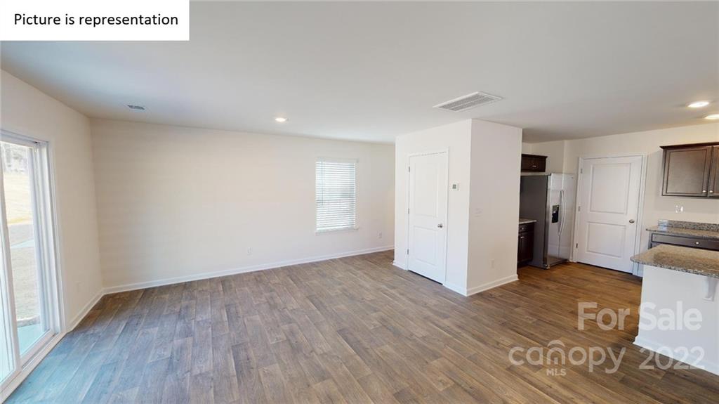 5026 Fandango Road York, SC 29745 - Photo 7 of 26 a view of a kitchen with wooden floor and a refrigerator