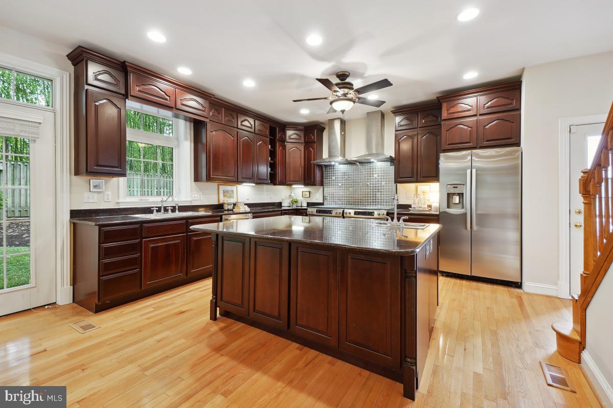 8610 Melwood Road Bethesda, MD 20817 - Photo 16 of 44 a kitchen with granite countertop stainless steel appliances and wooden cabinets