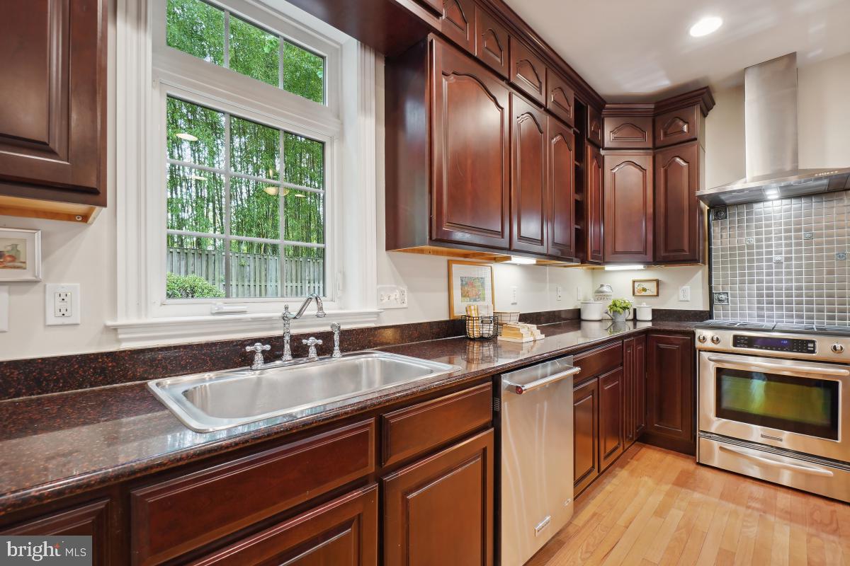 8610 Melwood Road Bethesda, MD 20817 - Photo 20 of 44 a kitchen with granite countertop stainless steel appliances a sink stove and cabinets