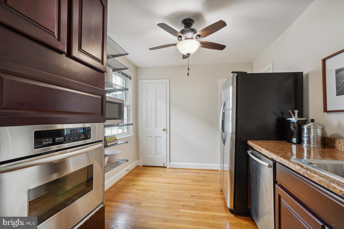 8610 Melwood Road Bethesda, MD 20817 - Photo 21 of 44 a kitchen with stainless steel appliances and chandelier