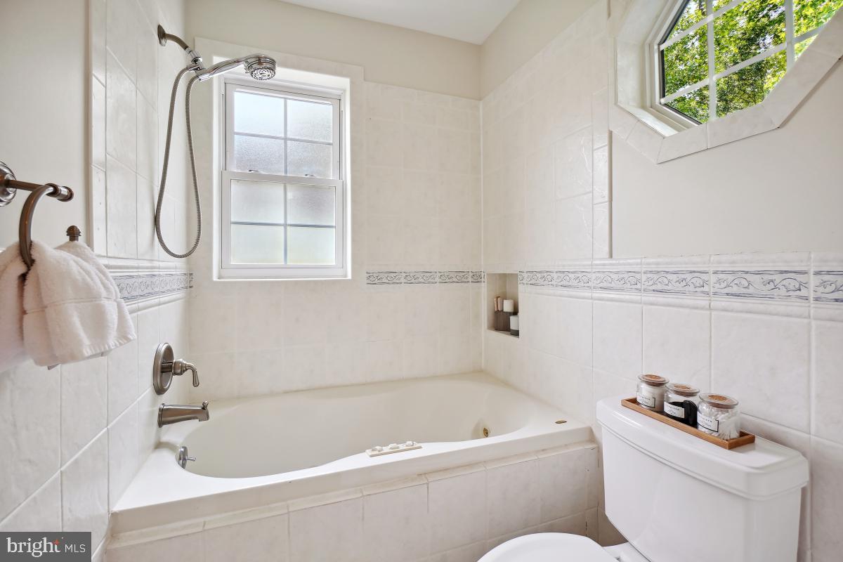 8610 Melwood Road Bethesda, MD 20817 - Photo 30 of 44 a bathroom with a toilet bathtub and shower