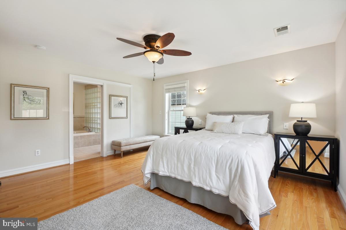 8610 Melwood Road Bethesda, MD 20817 - Photo 37 of 44 a bedroom with a bed and wooden floor