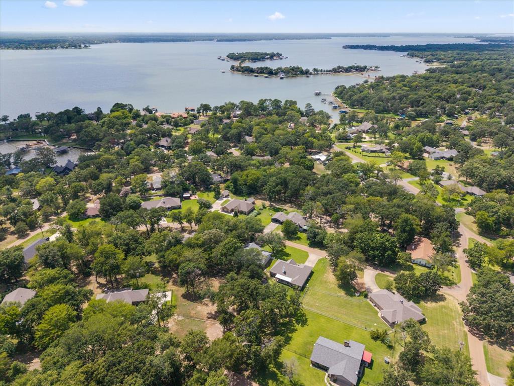 116 Meadowood Road Enchanted Oaks, TX 75156 - Photo 32 of 37 Lakefront community featuring a calm body of water, extensive tree cover, multiple residential properties, and private boat docks