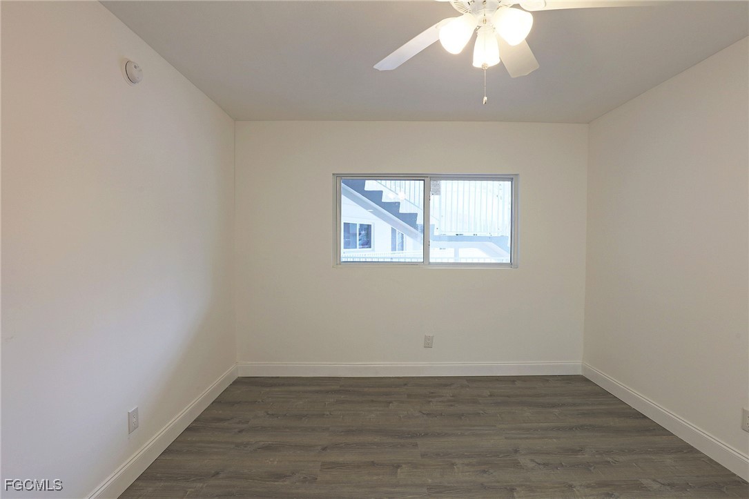 2590 First Street, Unit 105 Fort Myers, FL 33901 - Photo 12 of 13 an empty room with wooden floor and windows