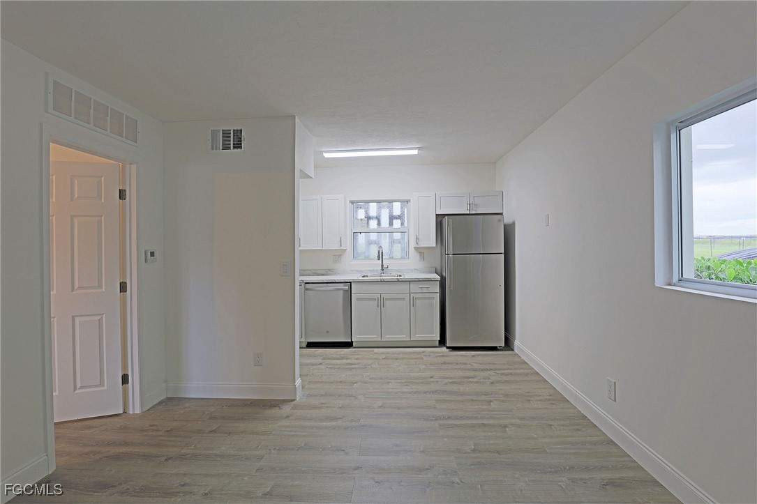 2590 First Street, Unit 105 Fort Myers, FL 33901 - Photo 6 of 13 a kitchen with stainless steel appliances a refrigerator and a stove top oven