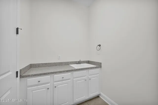 a spacious bathroom with a granite countertop tub sink a mirror a shower and vanity