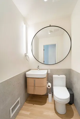 a bathroom with a sink a mirror and toilet