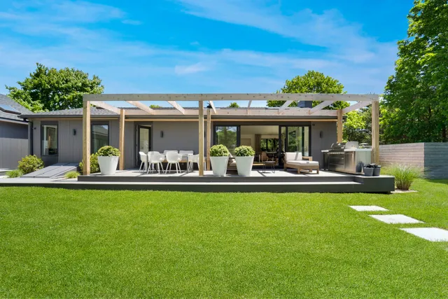 a view of a table and chairs in patio and a couple of lawn chairs