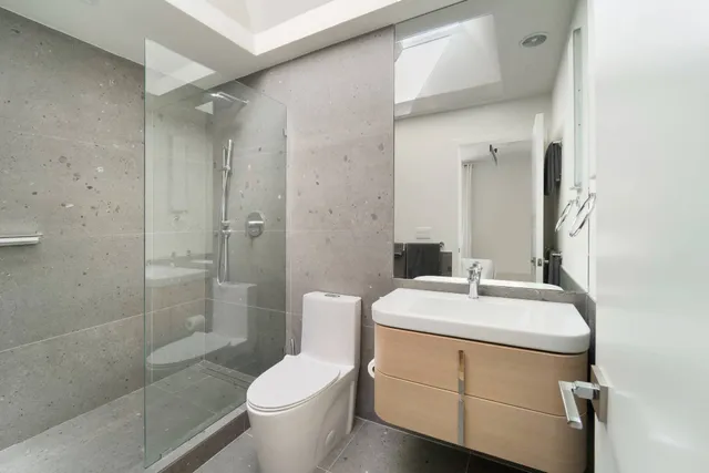 a bathroom with a sink toilet and shower