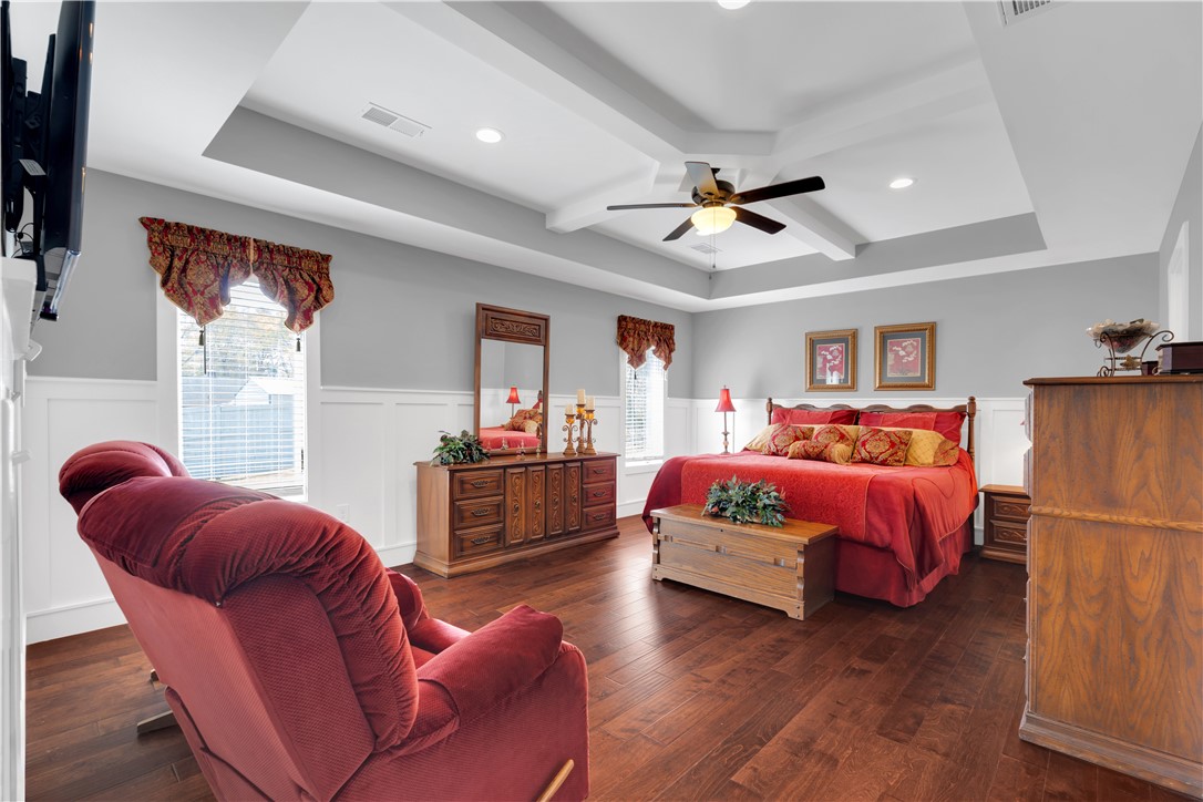 181 Amberwood Drive Anderson, SC 29621 - Photo 15 of 28 This spacious bedroom features warm wood flooring and a distinctive tray ceiling.