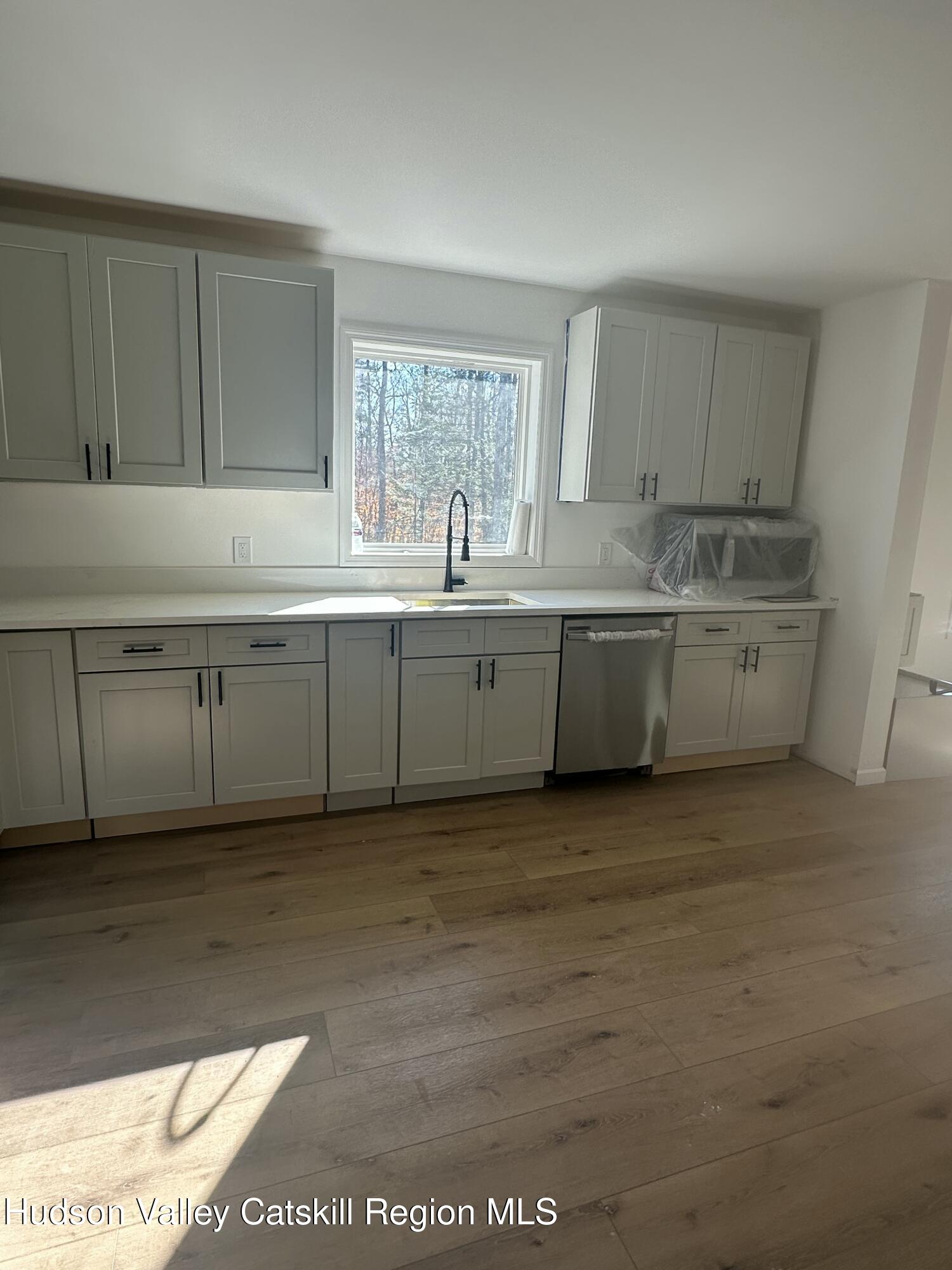20 Olivers Way Cairo, NY 12413 - Photo 11 of 20 a bathroom with a granite countertop sink and a mirror