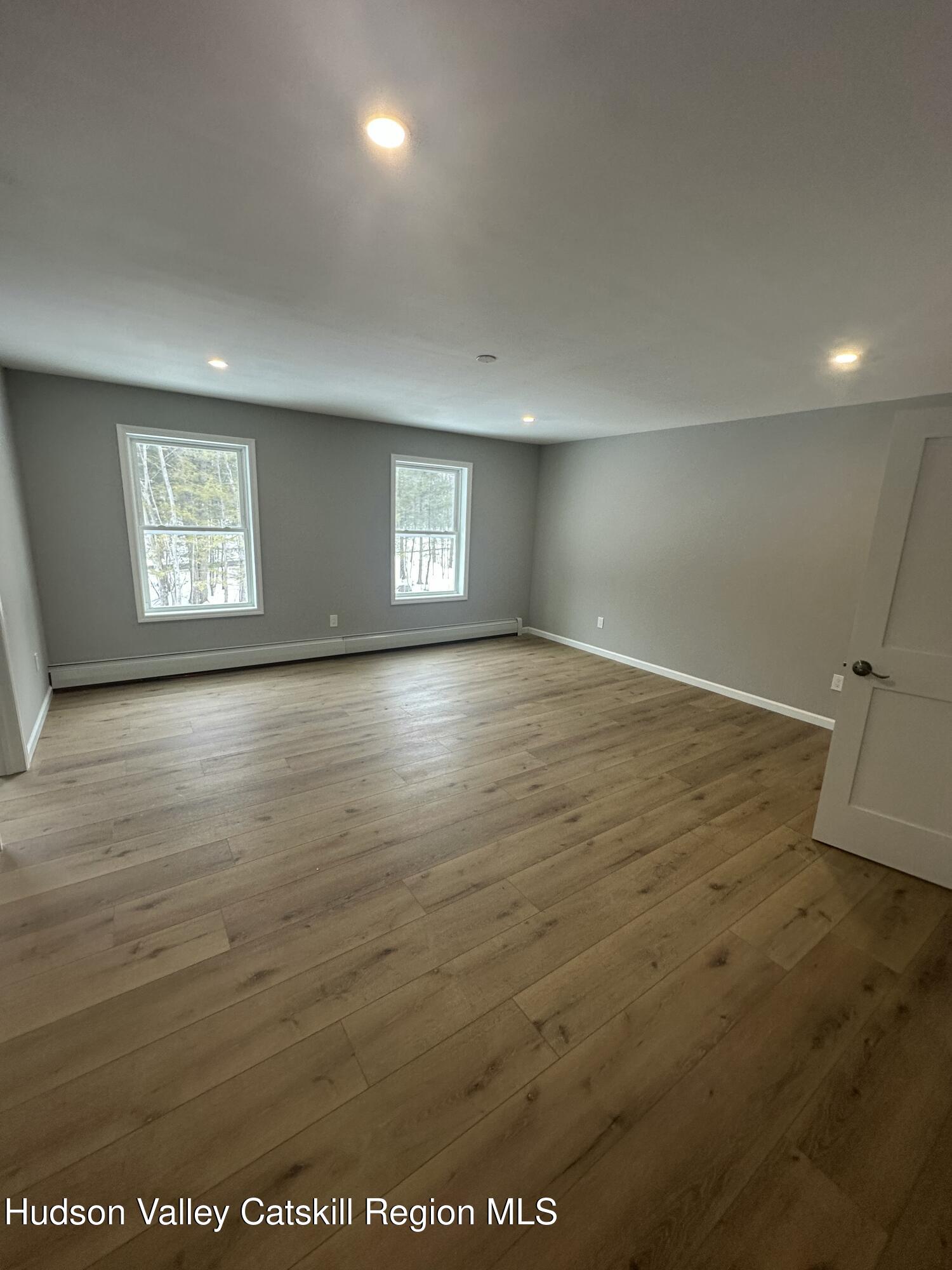 20 Olivers Way Cairo, NY 12413 - Photo 15 of 20 an empty room with wooden floor and windows