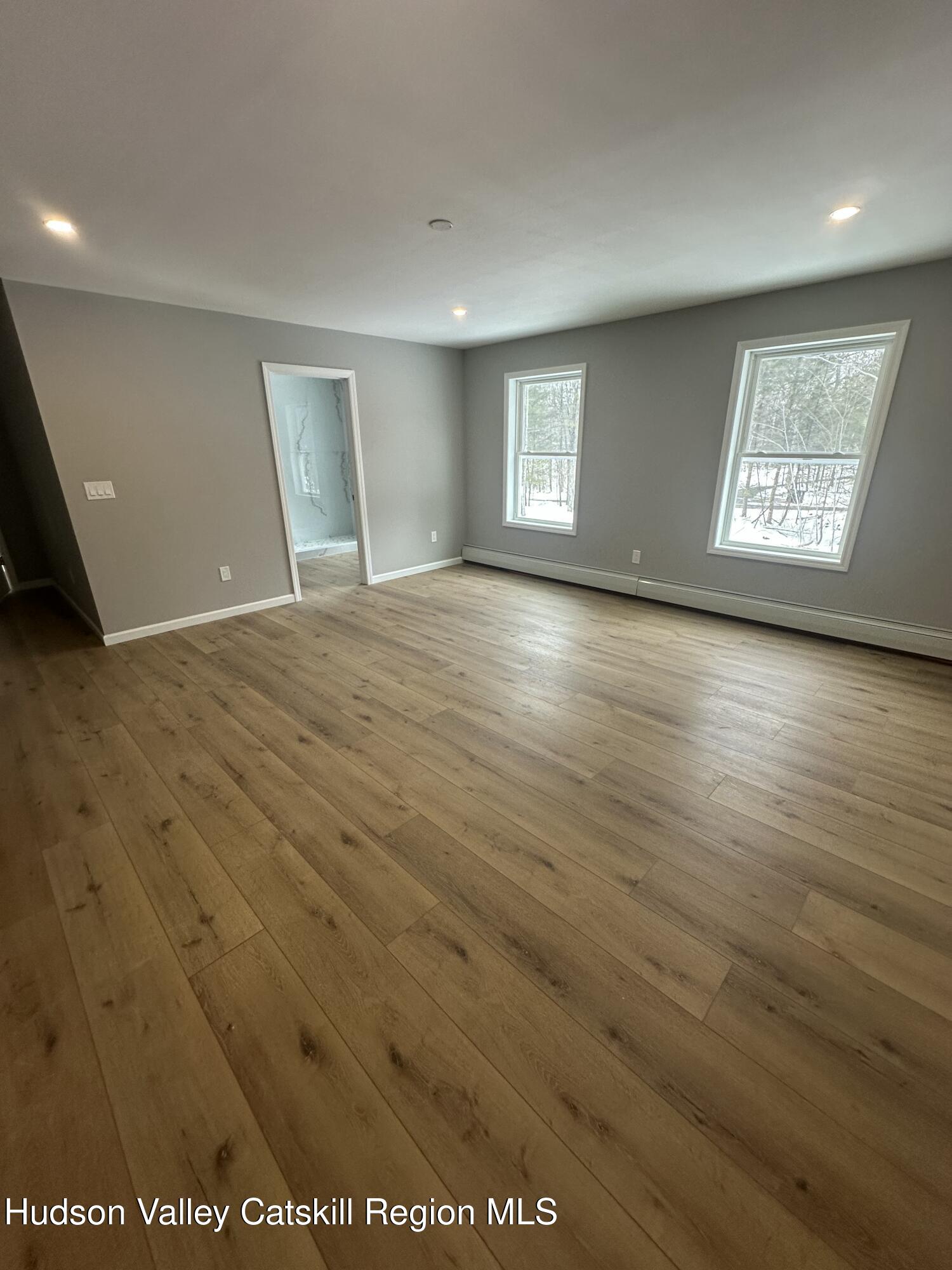 20 Olivers Way Cairo, NY 12413 - Photo 16 of 20 an empty room with wooden floor and windows