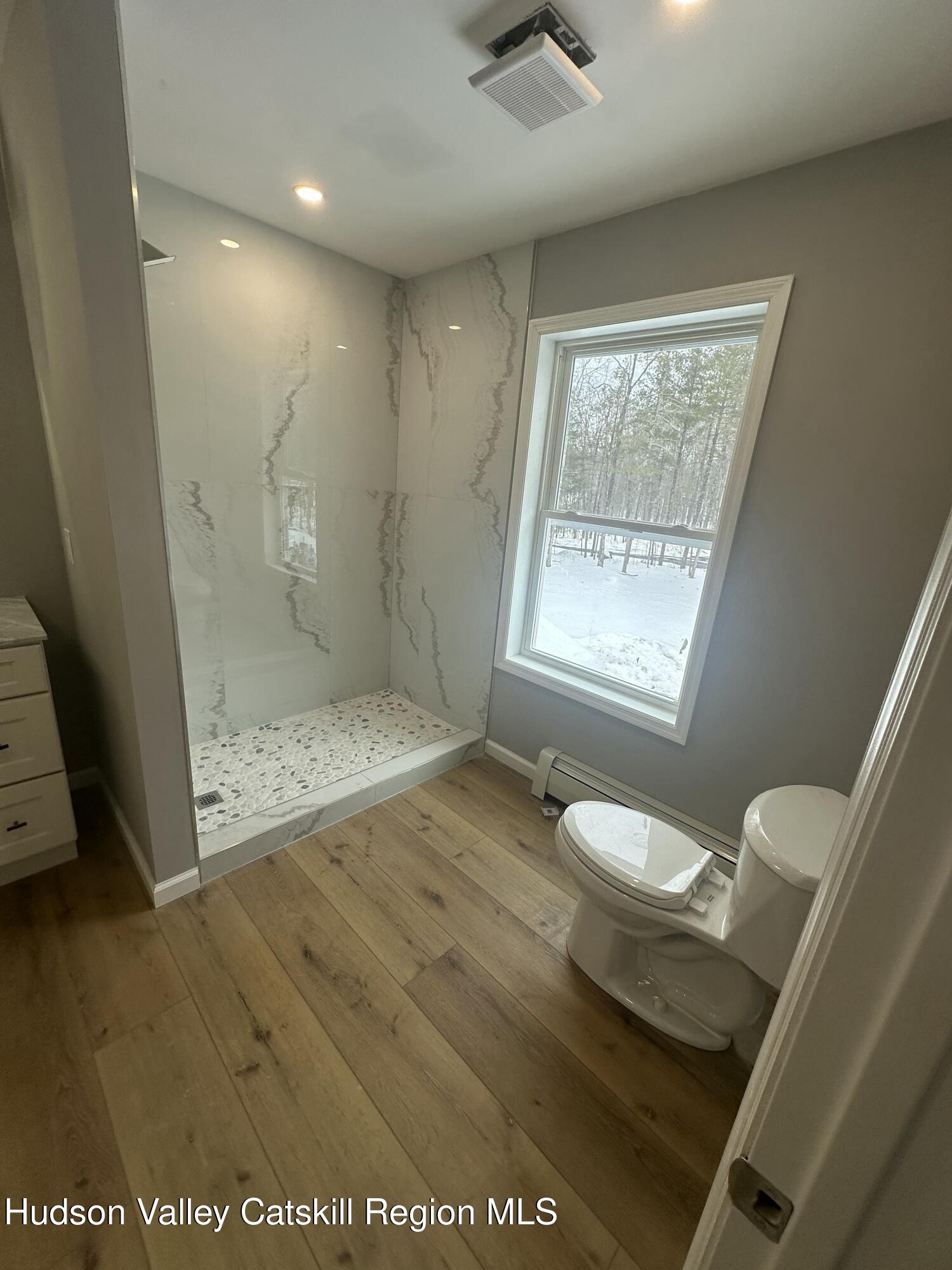 20 Olivers Way Cairo, NY 12413 - Photo 18 of 20 a bathroom with a granite countertop sink a toilet and shower