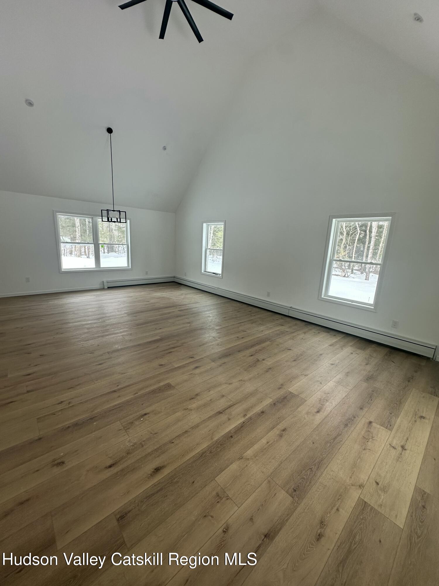 20 Olivers Way Cairo, NY 12413 - Photo 5 of 20 an empty room with wooden floor and windows