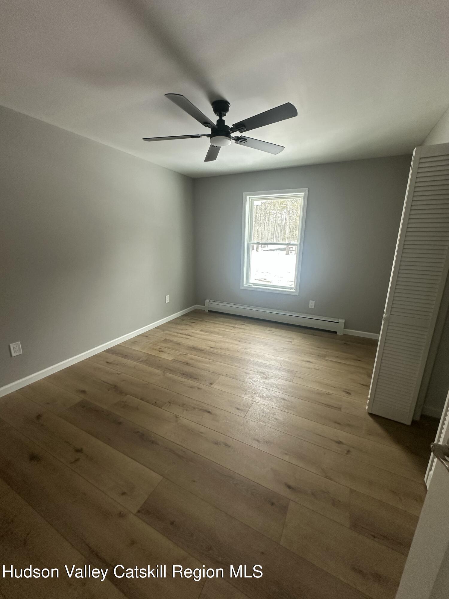 20 Olivers Way Cairo, NY 12413 - Photo 7 of 20 an empty room with wooden floor and windows