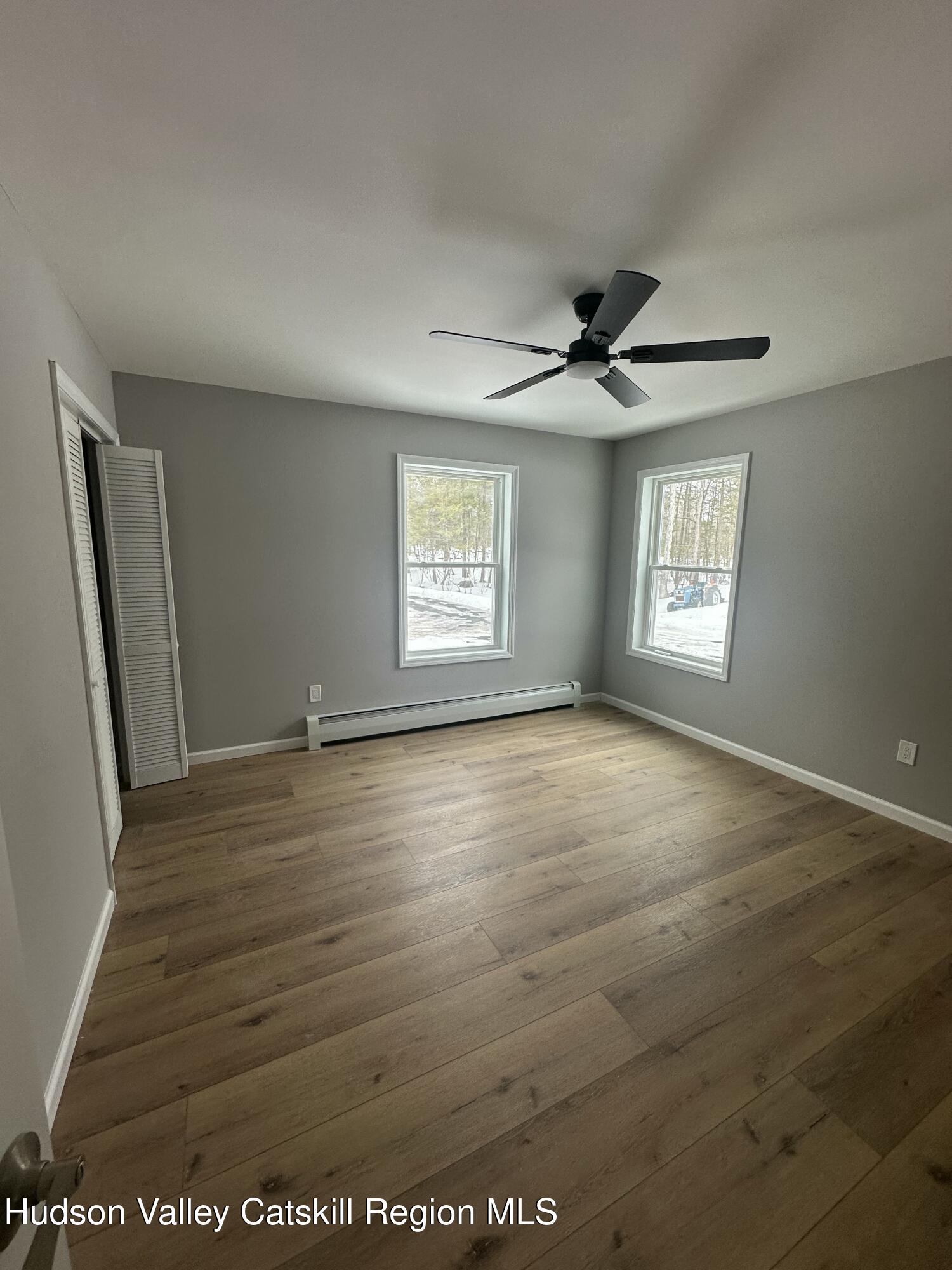 20 Olivers Way Cairo, NY 12413 - Photo 8 of 20 an empty room with wooden floor and windows
