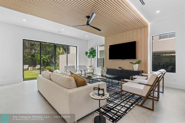 a kitchen with kitchen island a stove a table a sink refrigerator and cabinets