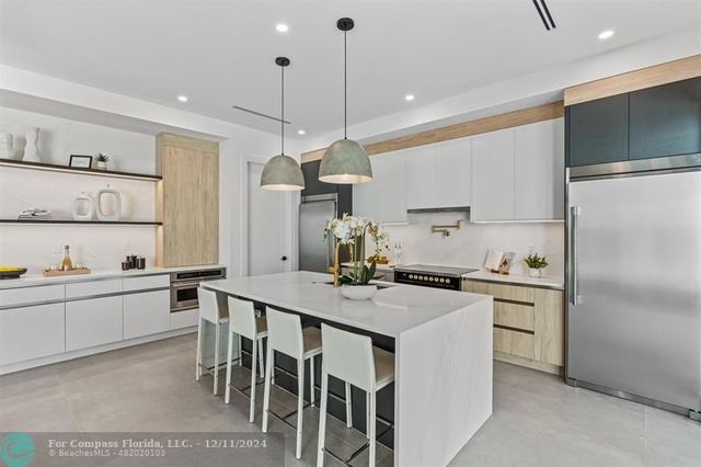 a bathroom with a double vanity sink and mirror with bathtub