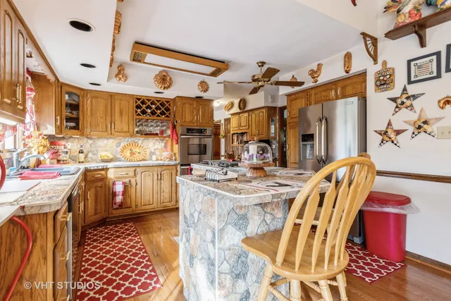 a kitchen with stainless steel appliances granite countertop a stove and a refrigerator