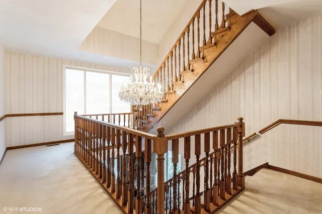 a bedroom with a bed and a large mirror on the dresser