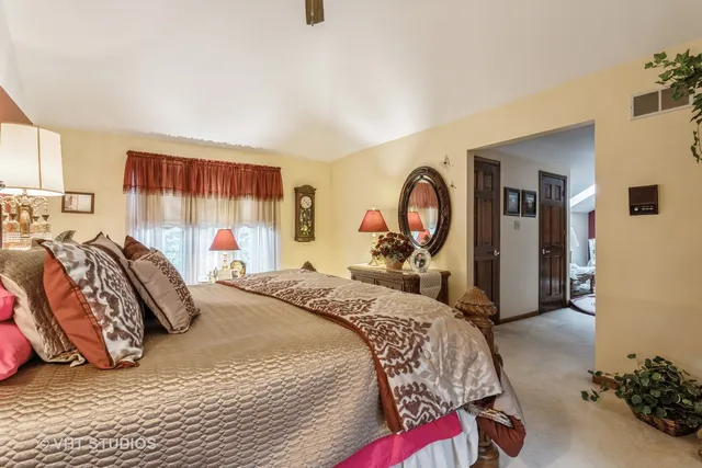 a bed room with a bed and a chair