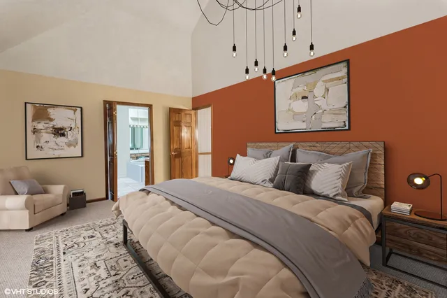 a bedroom with furniture and a lamp