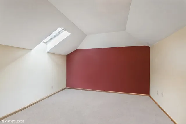 a large white kitchen with a large window and stainless steel appliances
