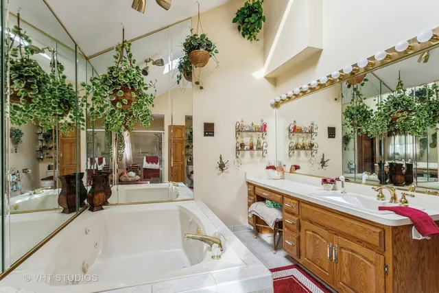 a spacious bathroom with a tub sink shower and mirror