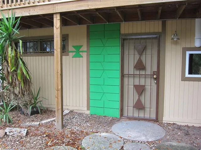 a couple of potted plants in front of door