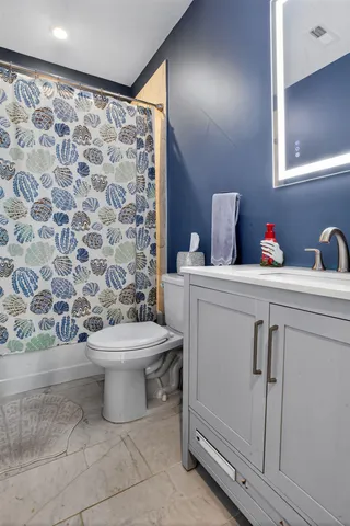 a bathroom with a toilet and a shower