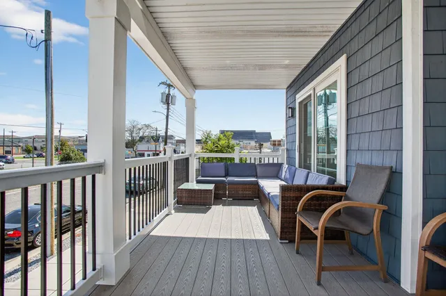 a view of a balcony with furniture and wooden floor