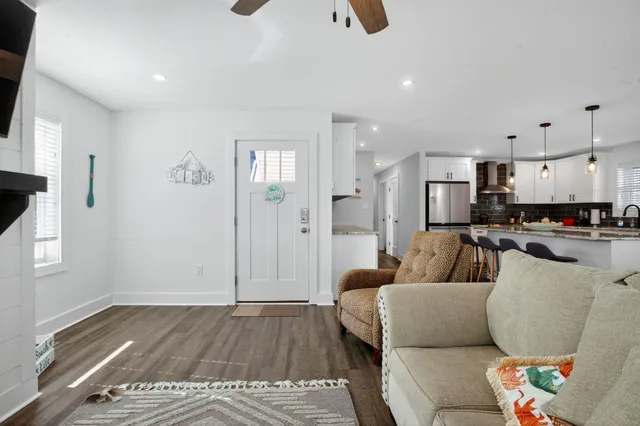 a kitchen with stainless steel appliances granite countertop a stove a sink and white cabinets