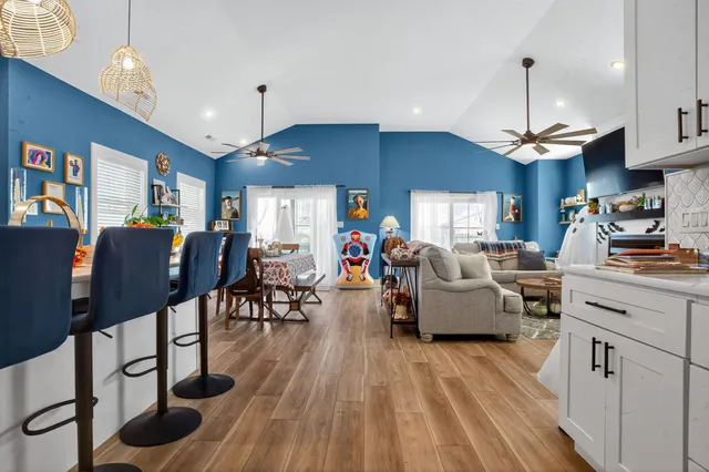a living room filled with furniture and a chandelier