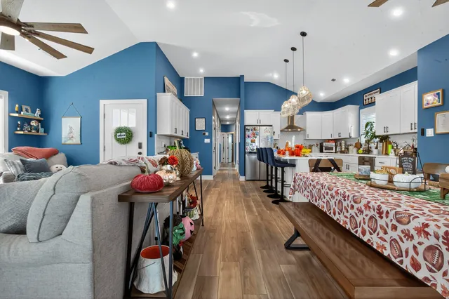 a living room with furniture a flat screen tv and a fireplace