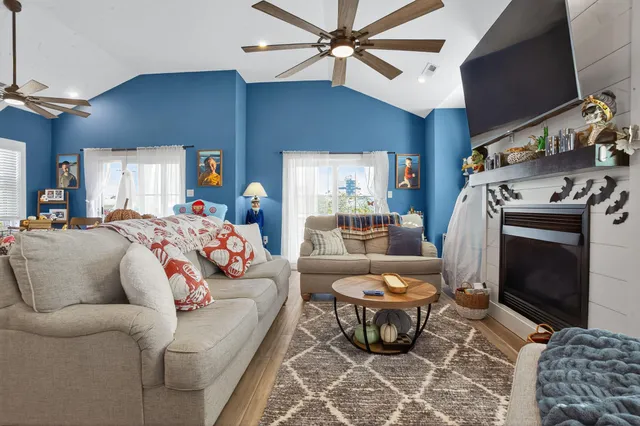 a view of a dining room with furniture a chandelier and wooden floor